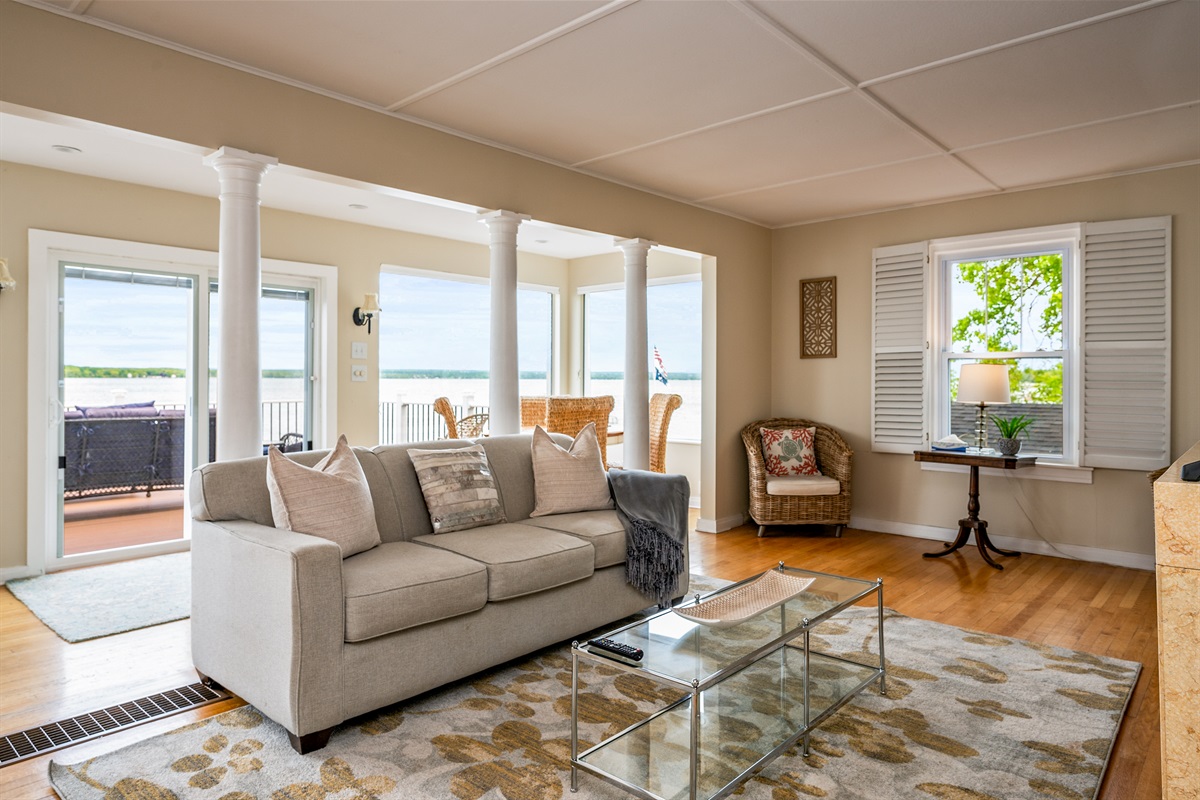 Bright and airy living space with panoramic lake views and direct access to the waterfront deck 🌊🛋️☀️