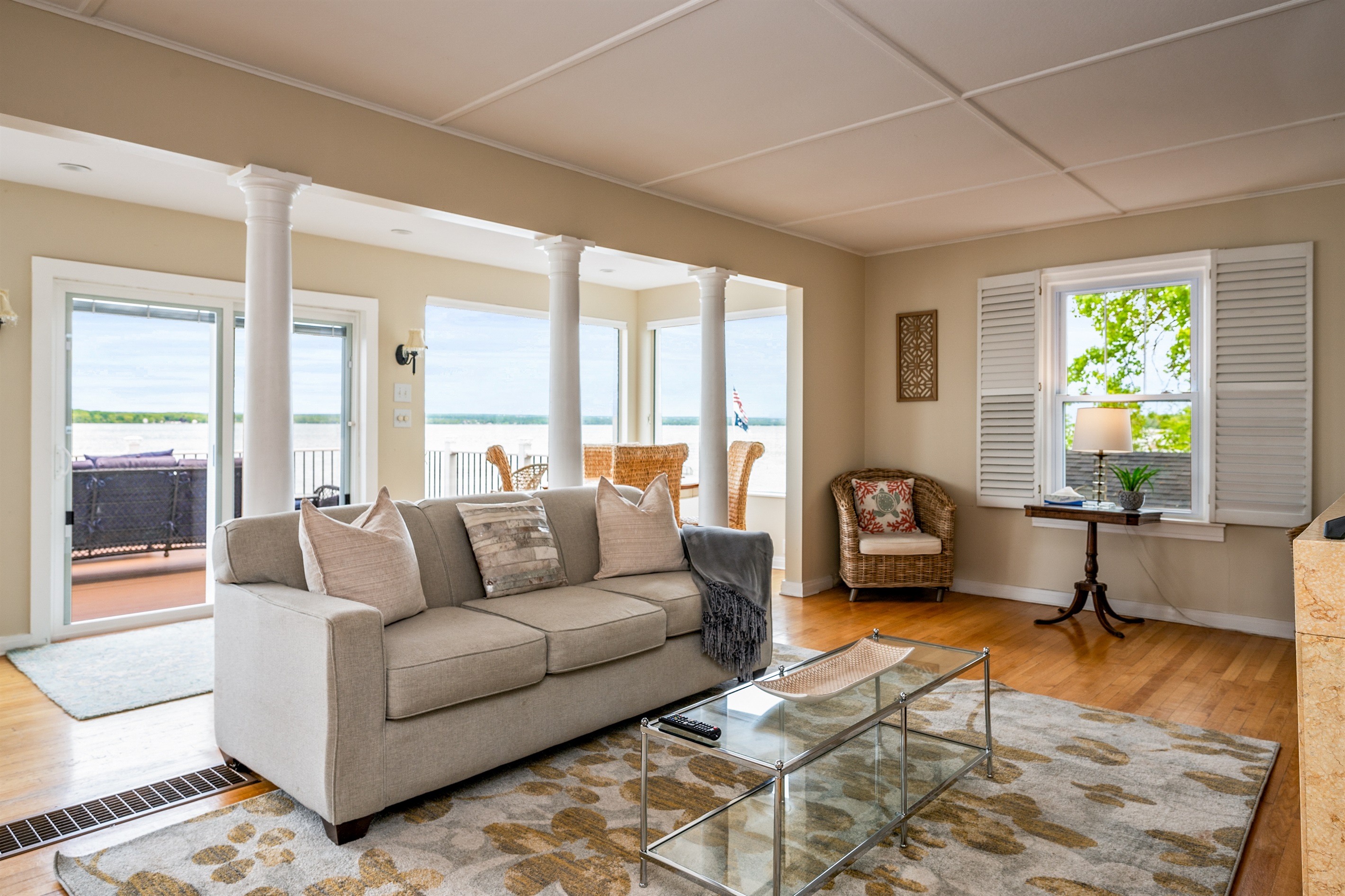 Bright and airy living space with panoramic lake views and direct access to the waterfront deck 🌊🛋️☀️