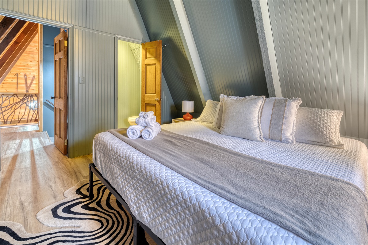 Bedroom #2 offers a comfortable king-sized bed and includes the convenience of an en-suite half bath.