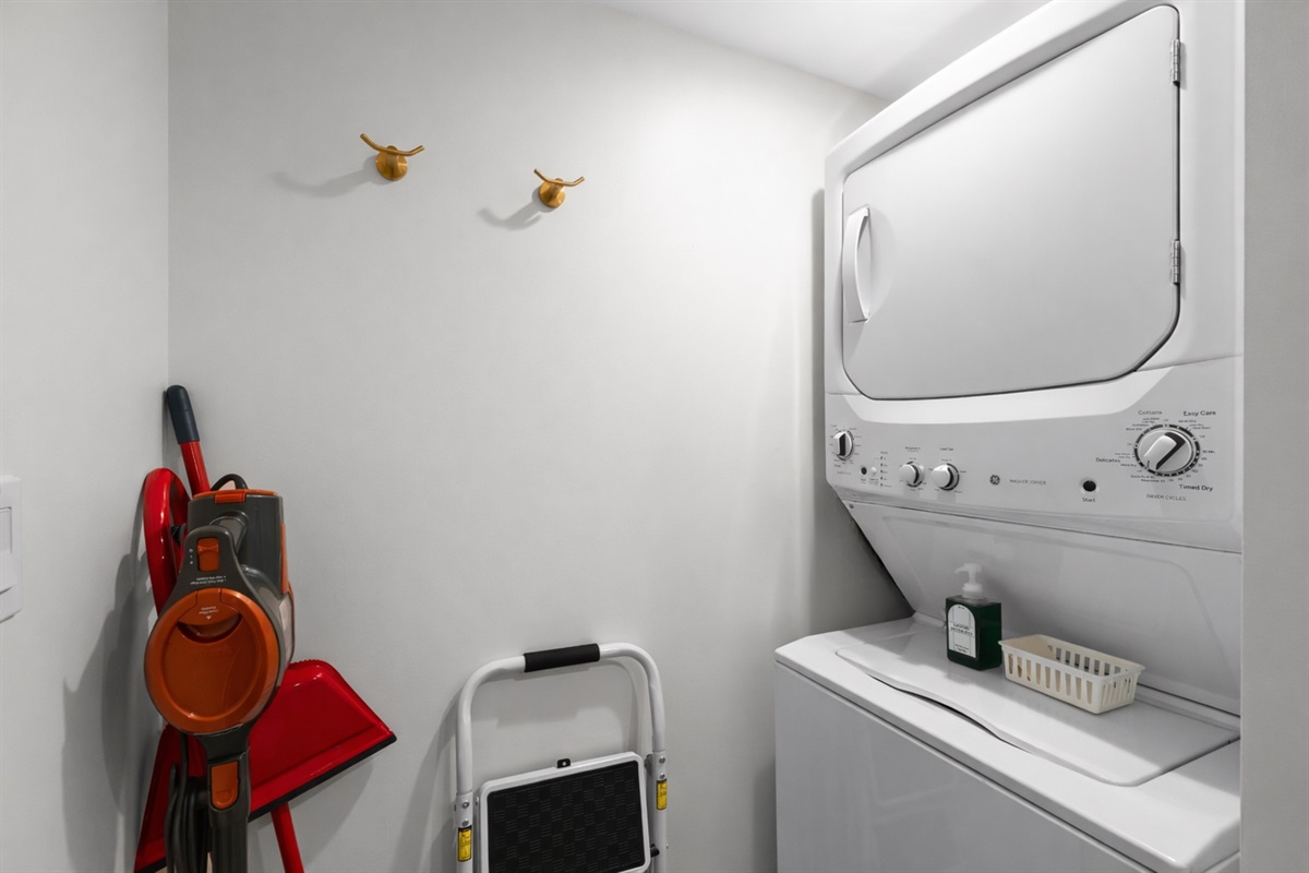 Convenient in-unit laundry area with washer and dryer, plus thoughtfully stored essentials—making longer stays easy and hassle-free.