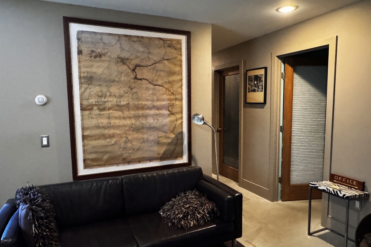 Lower level lounge featuring oversized vintage map artwork of Mount Desert Island. This dedicated social space is the perfect spot for groups to gather and plan their next Acadia National Park hiking route or day of island exploration.