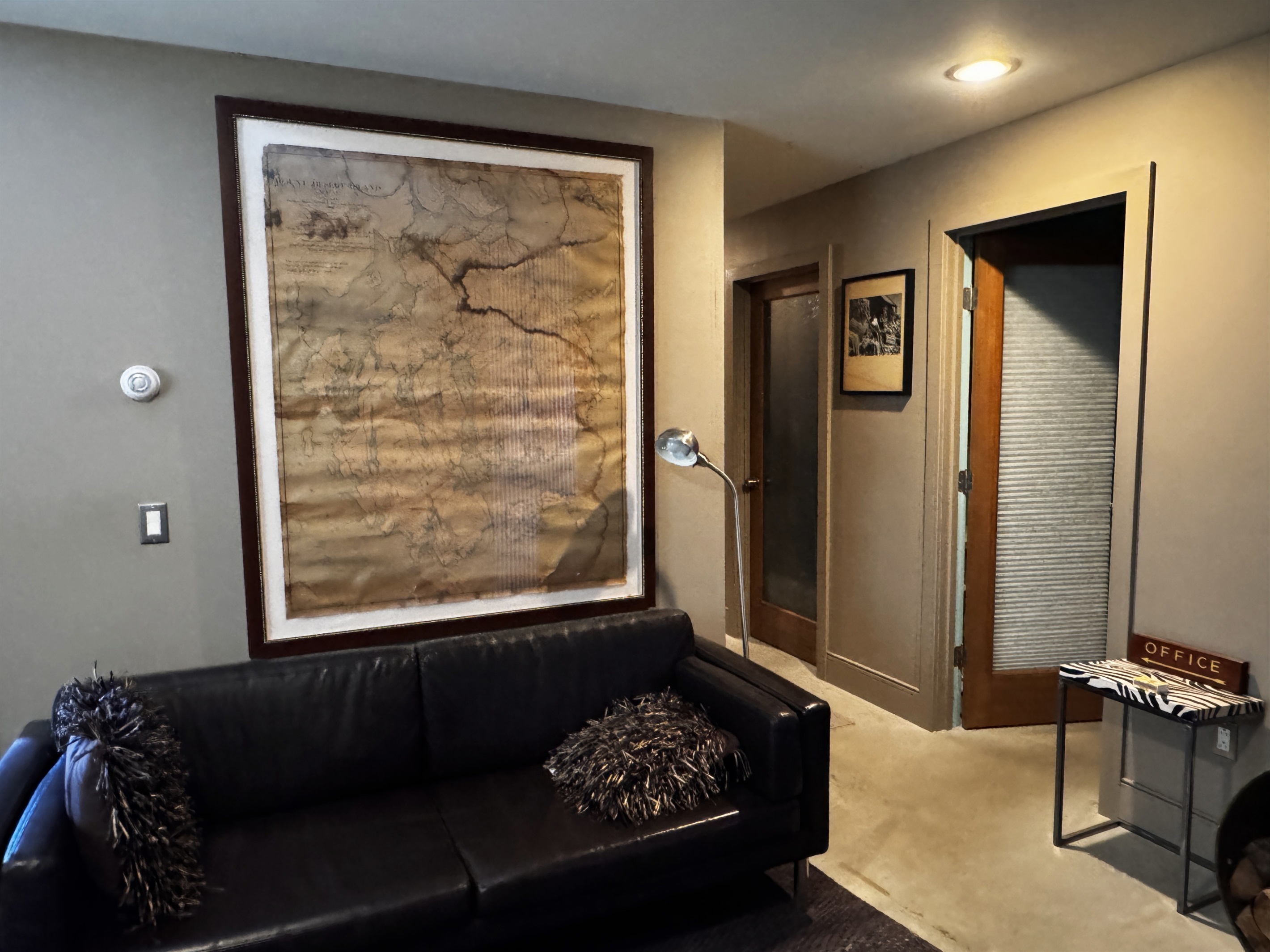 Lower level lounge featuring oversized vintage map artwork of Mount Desert Island. This dedicated social space is the perfect spot for groups to gather and plan their next Acadia National Park hiking route or day of island exploration.