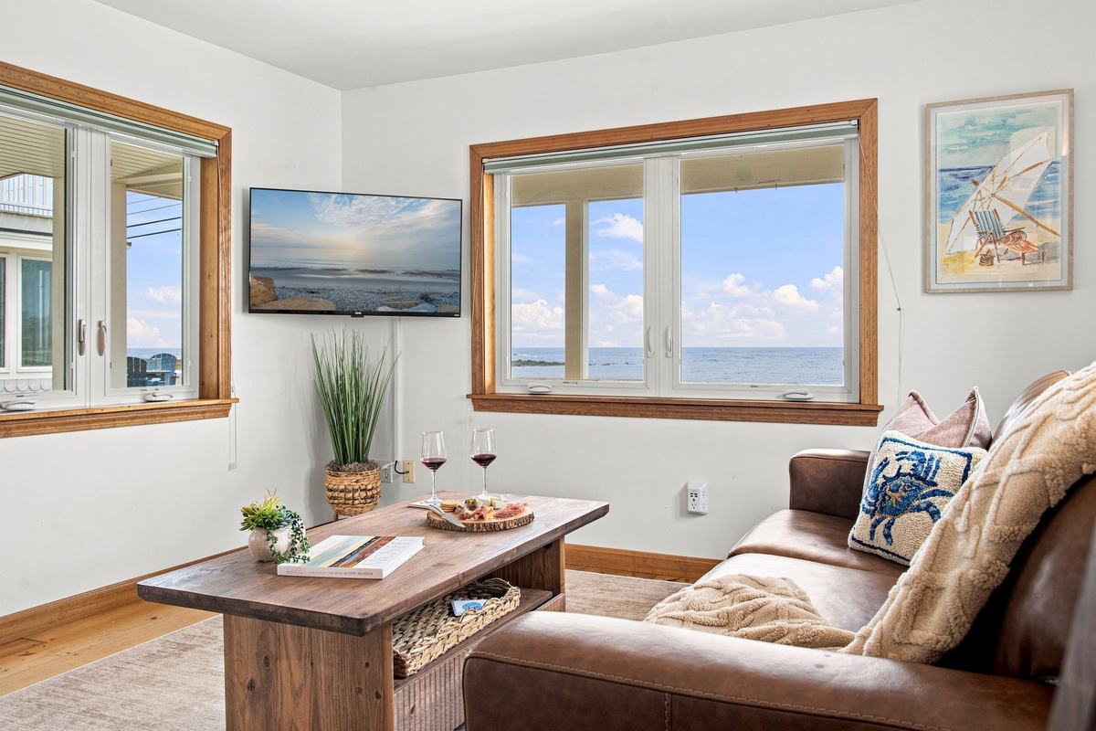 Cozy living room with comfortable seating, Smart TV, and panoramic ocean views.