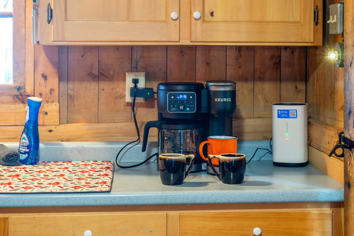 Coffee bar station at Loonrise Point! Features a dual-function Keurig K-Duo for single-serve pods or full carafe brewing, plus high-speed Wi-Fi router for easy connectivity on Beech Hill Pond in Otis, ME. Start your morning right!