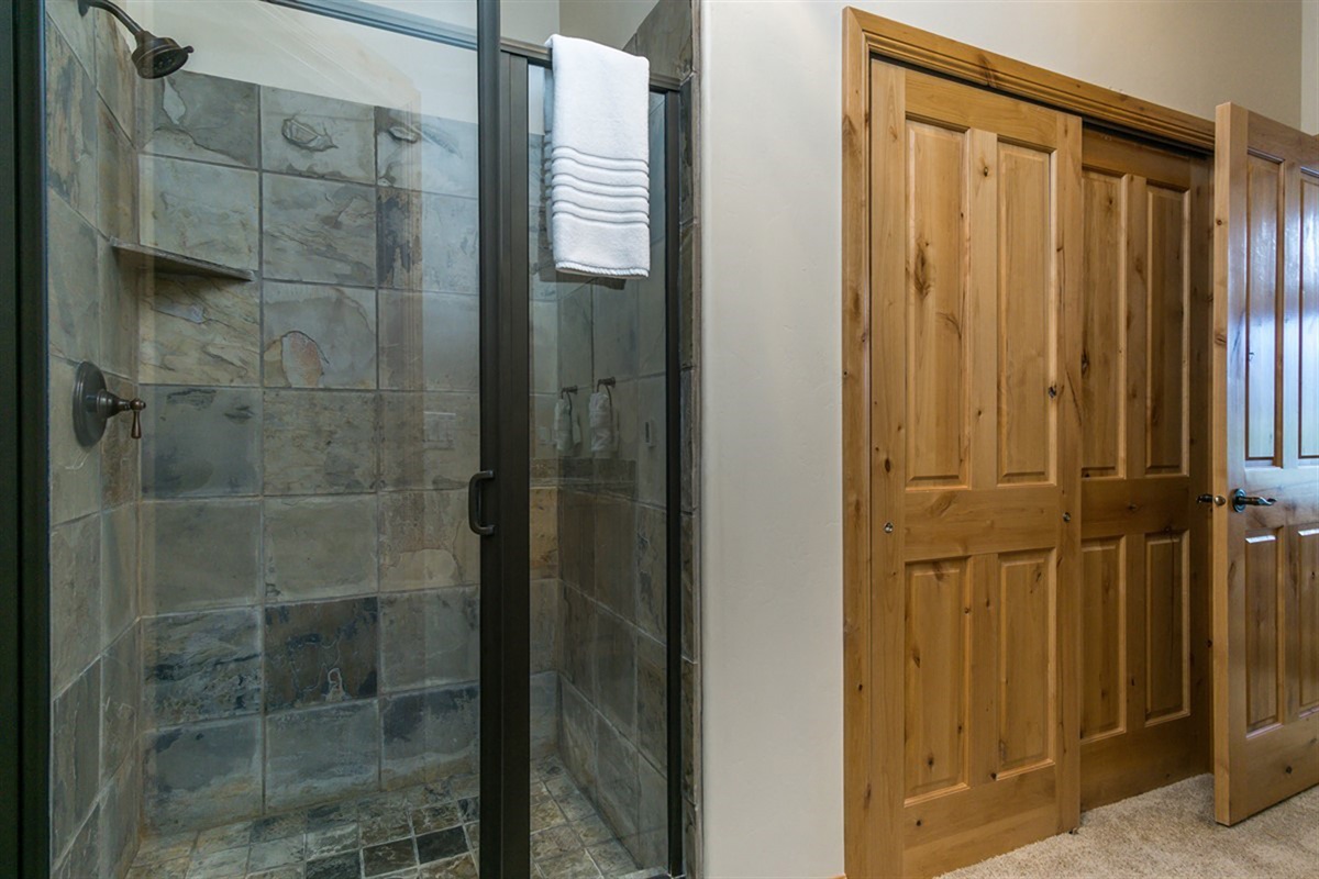 A beautifully tiled walk-in shower providing a spa-like experience, ideal for unwinding after a day of adventure in the mountains.