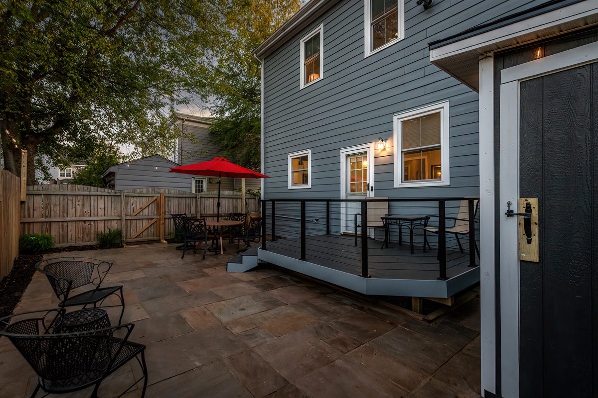 Outdoor Oasis: Enjoy al fresco dining under the red umbrella in your private, fenced patio!