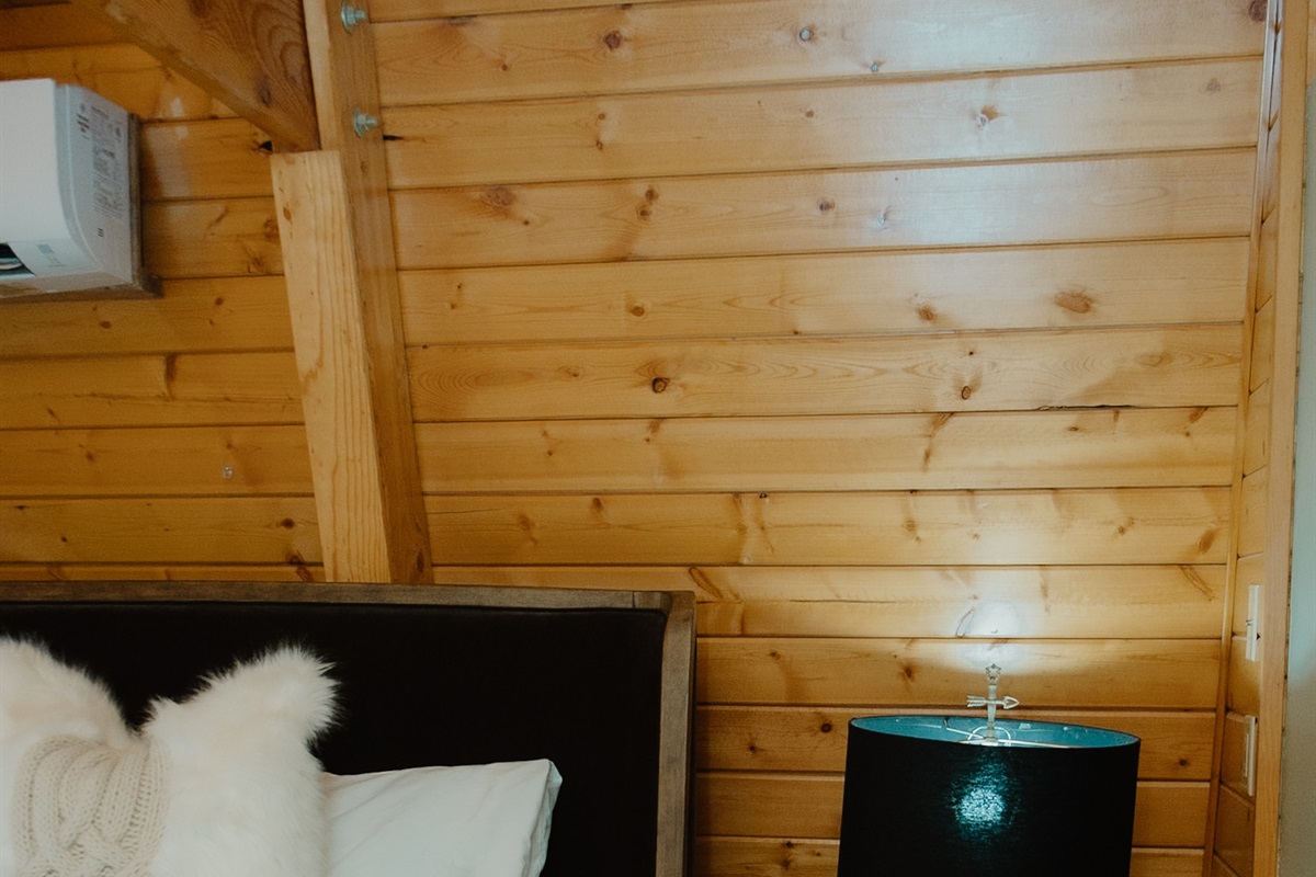 The comfy king bedroom at features crisp linens and a personal split unit for ultimate comfort. This cozy Show Low A-frame offers restful nights surrounded by ponderosa pines, perfect after exploring White Mountains hiking trails and fishing.