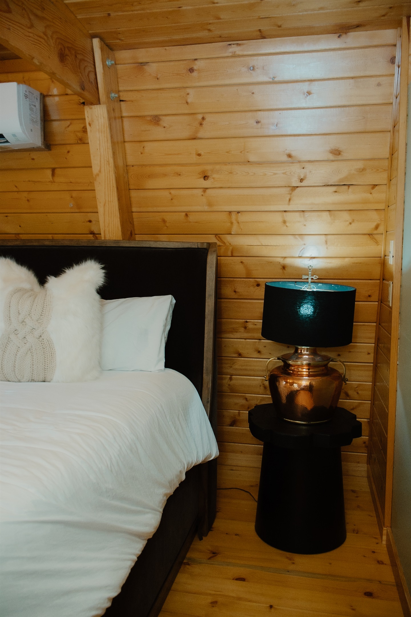 The comfy king bedroom at features crisp linens and a personal split unit for ultimate comfort. This cozy Show Low A-frame offers restful nights surrounded by ponderosa pines, perfect after exploring White Mountains hiking trails and fishing.