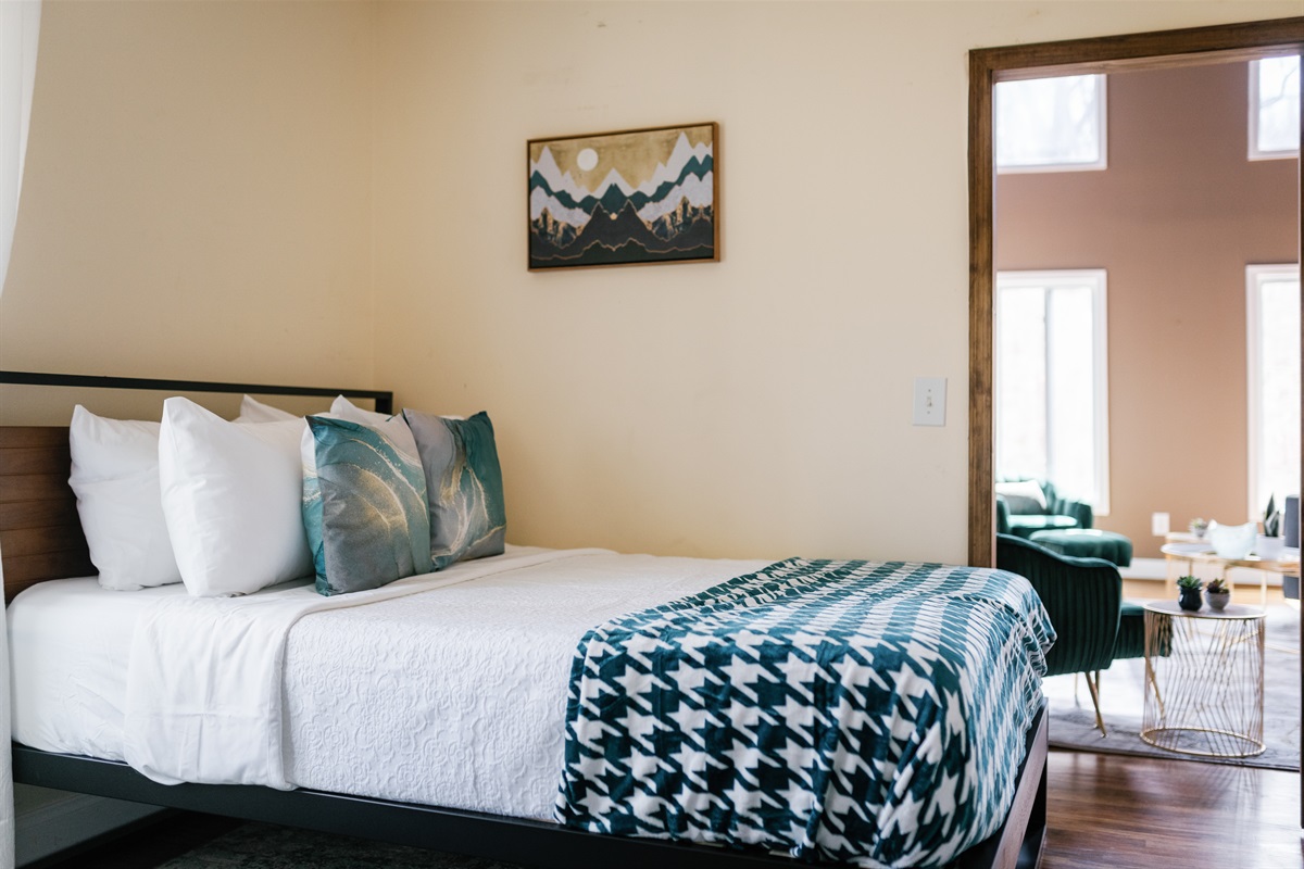 Main level bedroom (BR 1) with 2 queen beds & TV