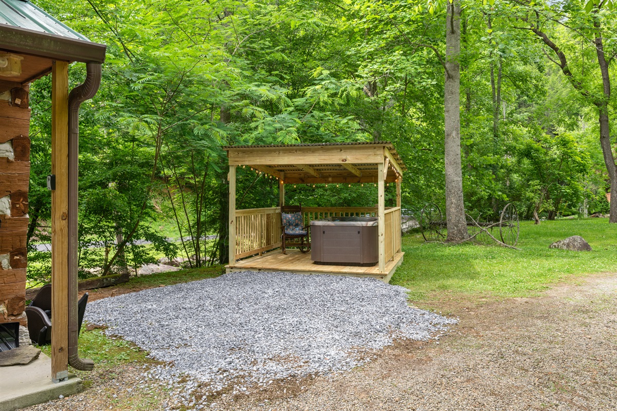 Gazebo on right side of cabin has hot tub steps from the stream with cafe lights!