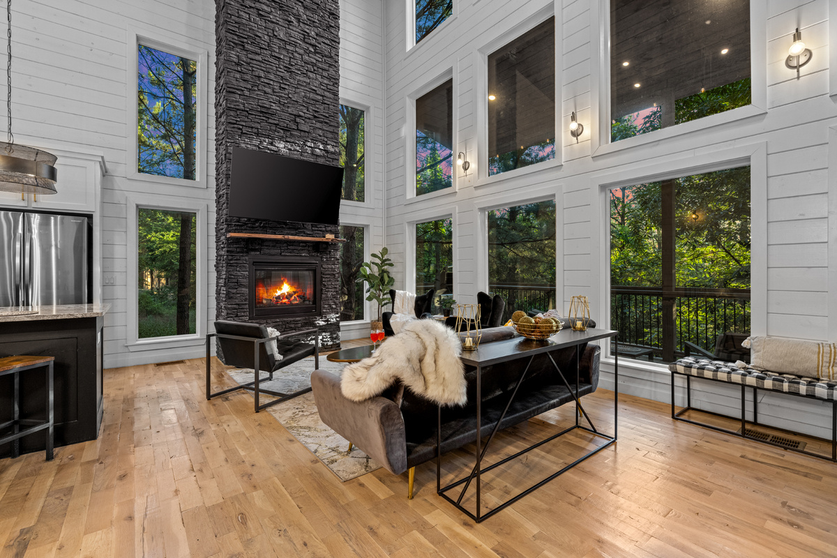 Spacious hangout area with comfortable seating around the fireplace and a TV, ideal for unwinding together.