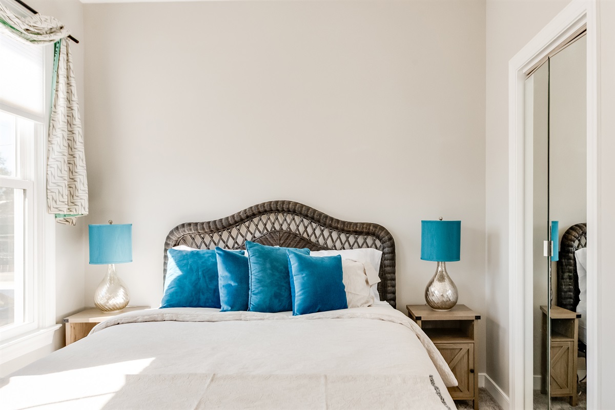 Queen Bedroom 2: Bright, inviting space with plush pillows and stylish decor for ultimate relaxation!