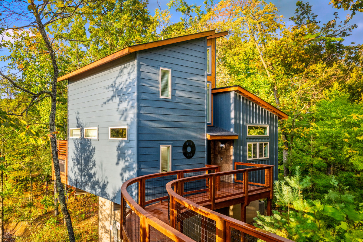 Blue treehouse-style cabin built August 2025 - in-town location with easy road access, no white-knuckle mountain switchbacks or nerve-wracking drives. Walk up and check in.