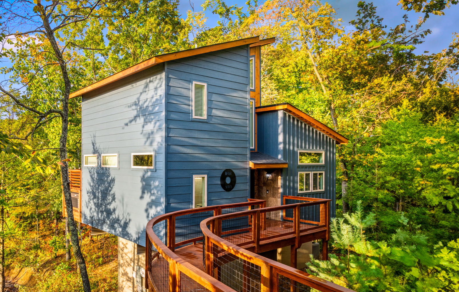 Blue treehouse-style cabin built August 2025 - in-town location with easy road access, no white-knuckle mountain switchbacks or nerve-wracking drives. Walk up and check in.