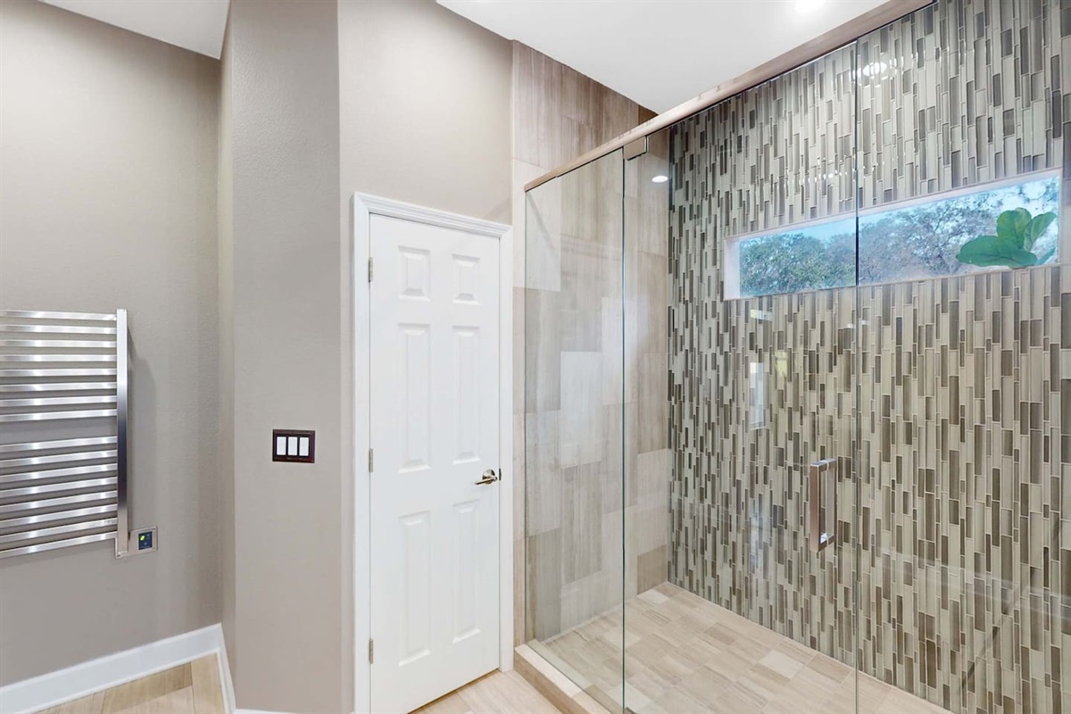 Stylish bath w/ textured stone wall & soft glow.