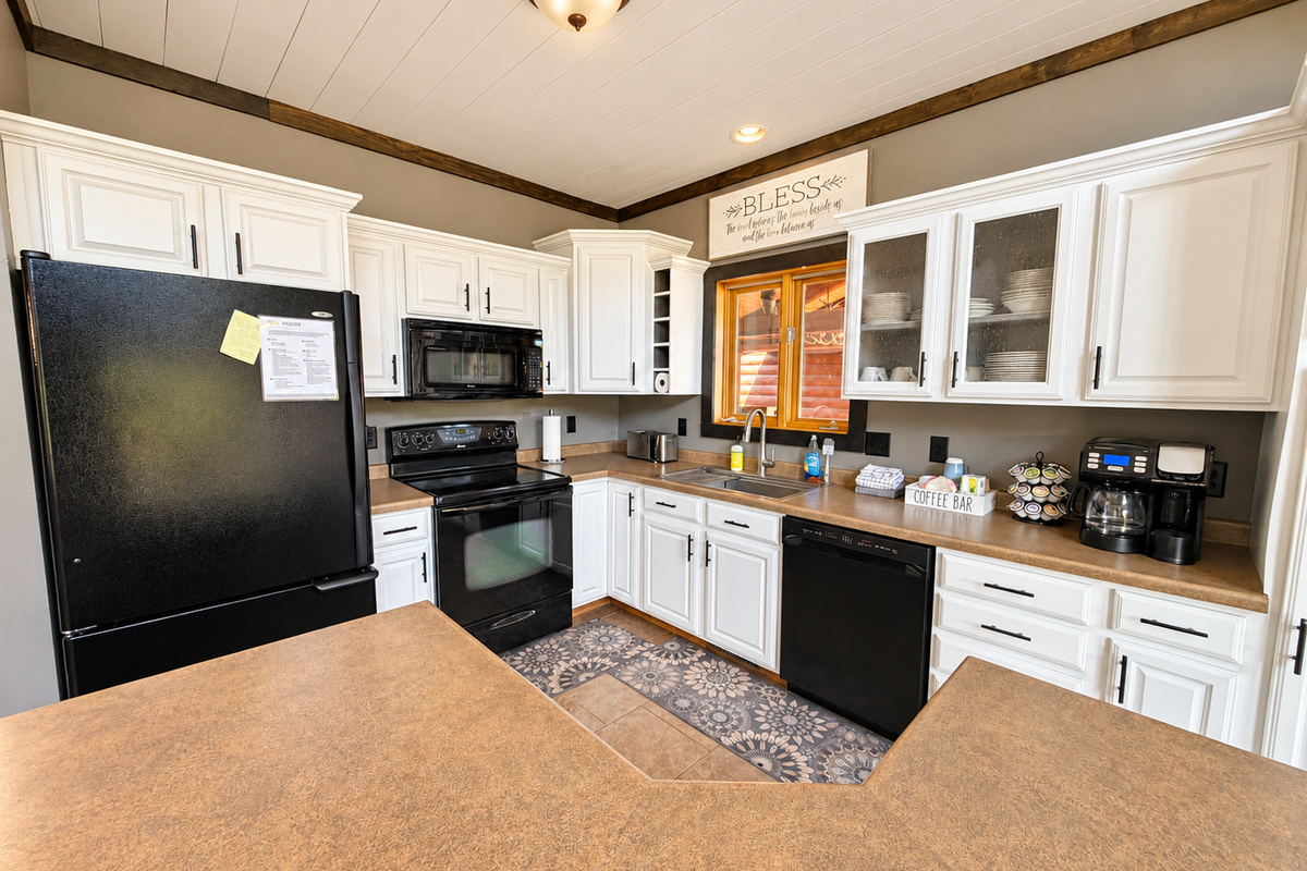 The fully stocked kitchen is ready for your stay, with modern appliances, a coffee maker, K-cups, and plenty of essentials for preparing everything from quick breakfasts to full group meals.