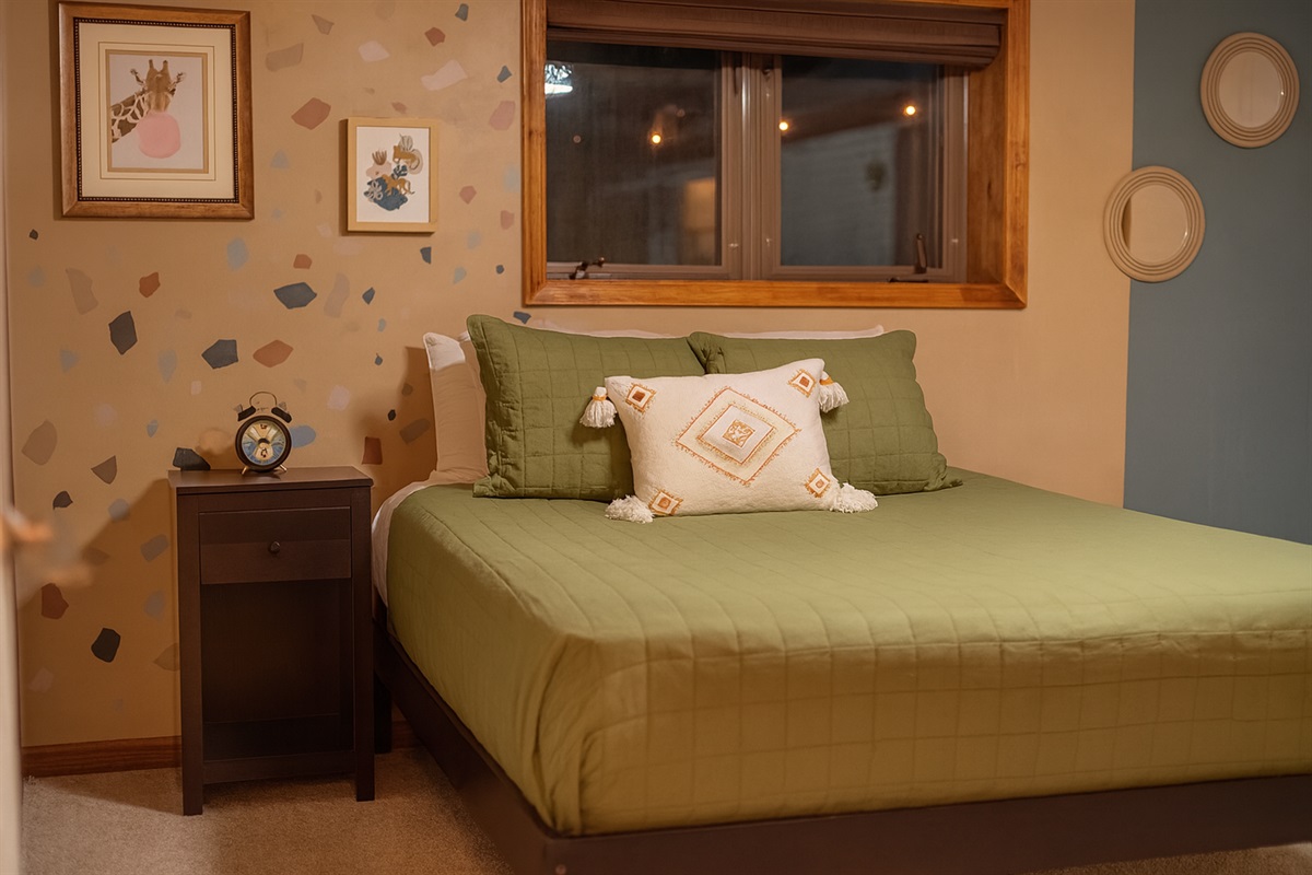 This lower-level bedroom features a cozy queen bed for comfort and sweet dreams.