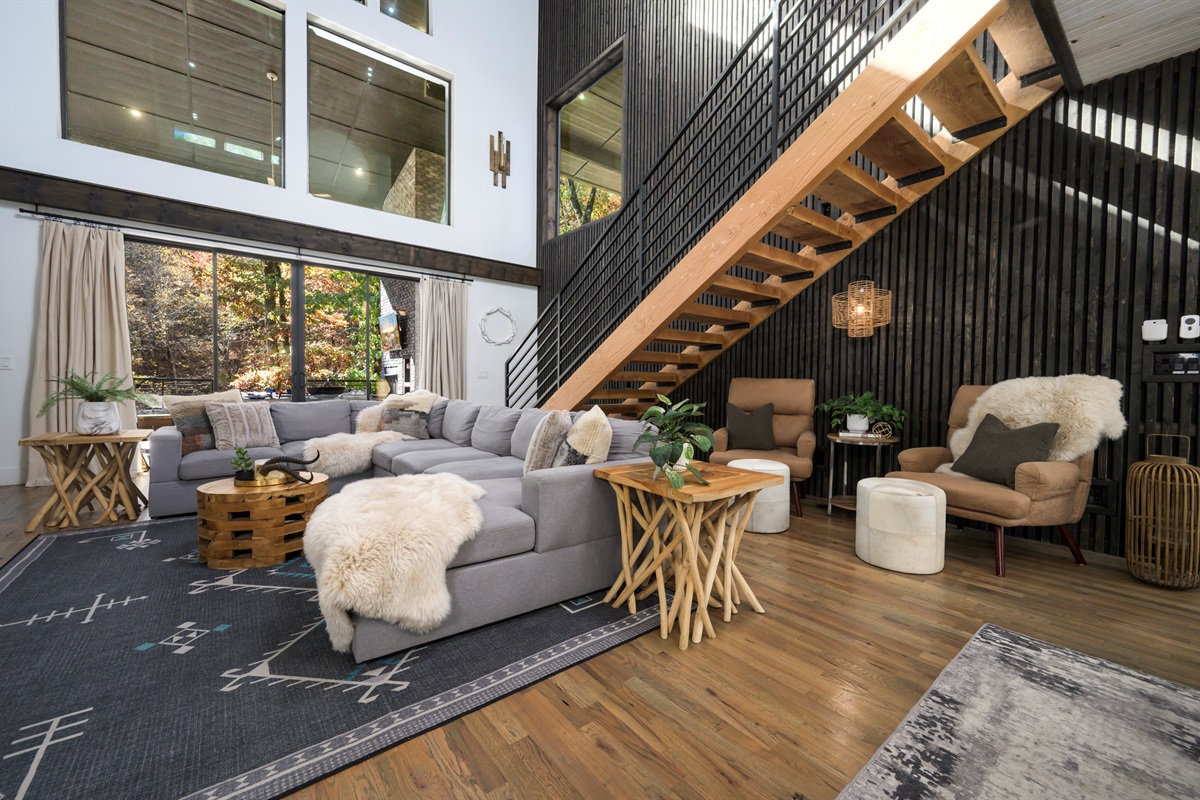 An open, light-filled living room where modern luxury meets cabin comfort, perfect for gathering and unwinding together