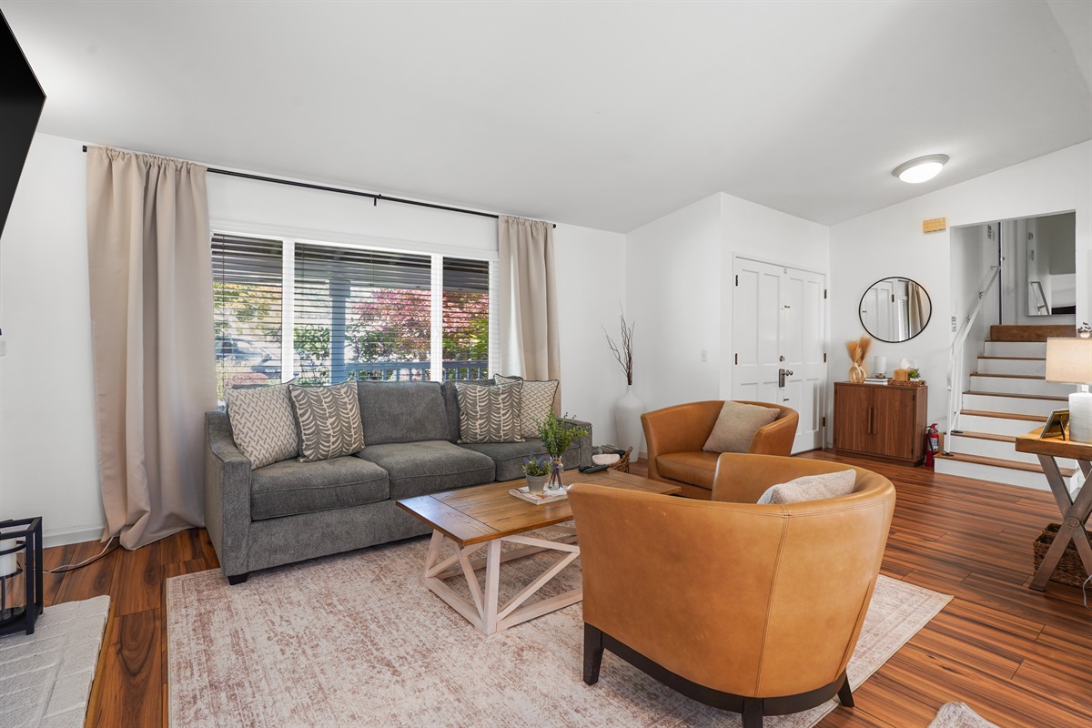 A living room that feels both elevated and effortless, with warm textures, natural light, and room to truly unwind.