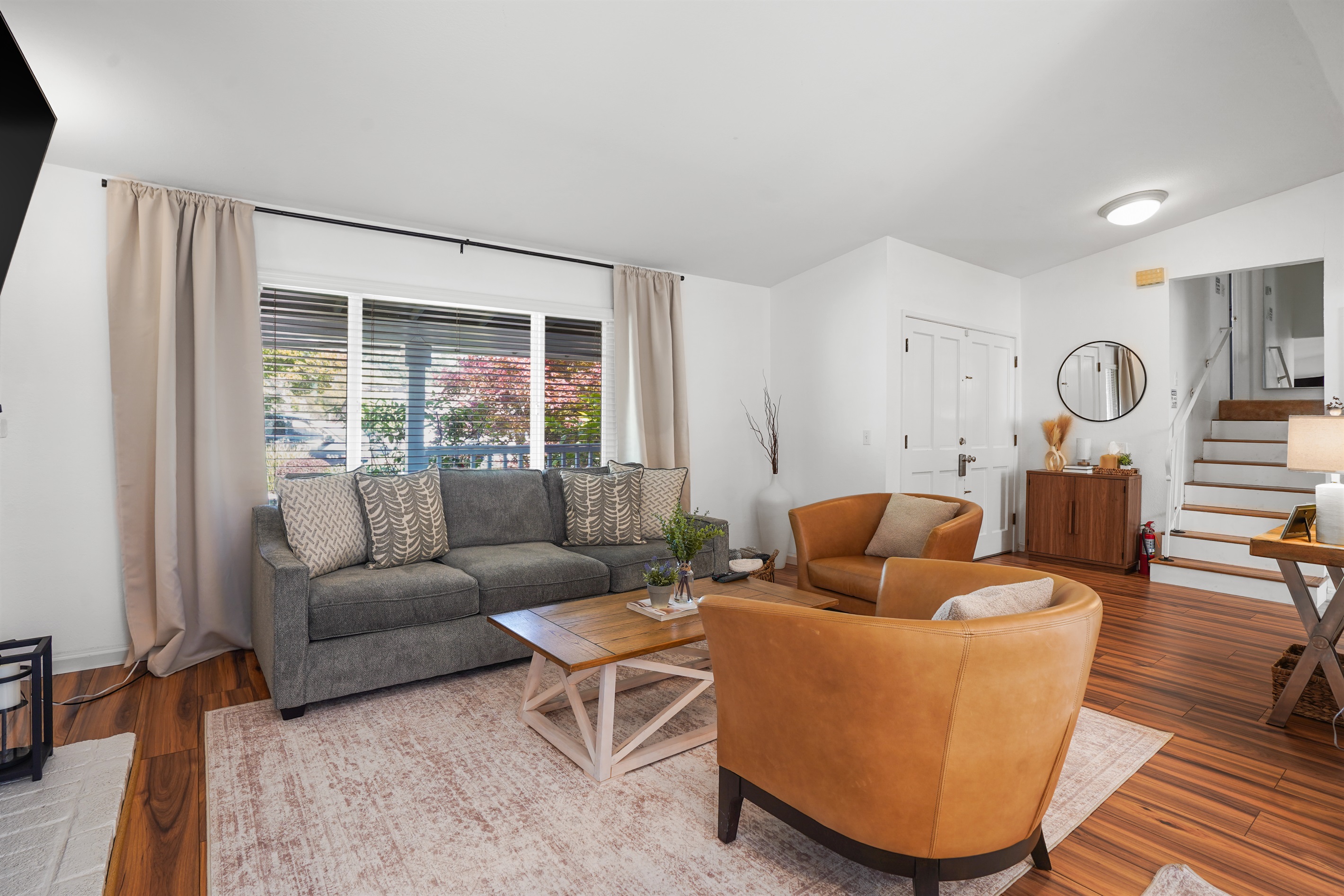 A living room that feels both elevated and effortless, with warm textures, natural light, and room to truly unwind.