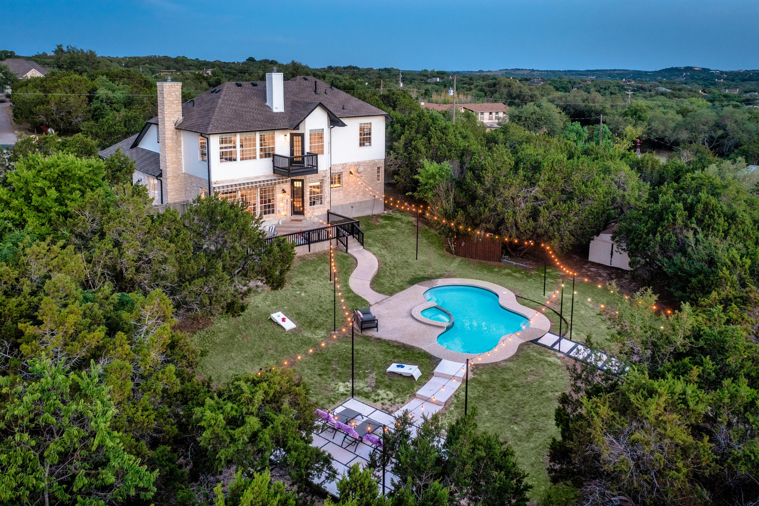 Aerial view showcases the private pool and sprawling greenbelt lot.