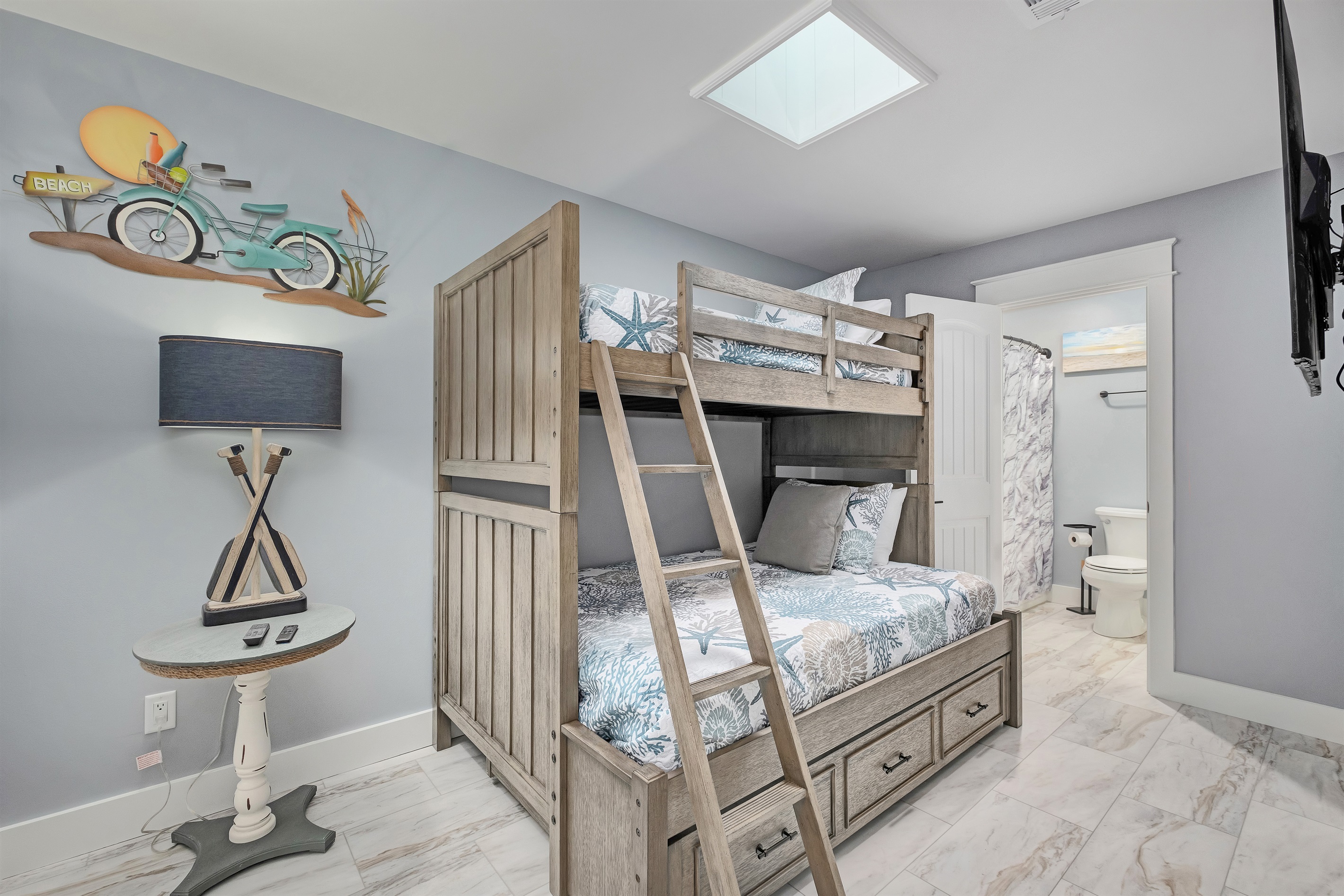Comfortable bunk bed (twin over full with a full trundle underneath) room with charming nautical decor. Ideal for kids and family-friendly stays.
