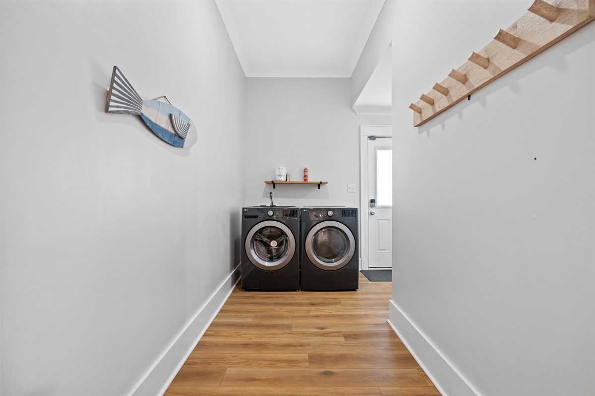 Convenient first-floor laundry area with full-size washer and dryer for added ease during extended stays