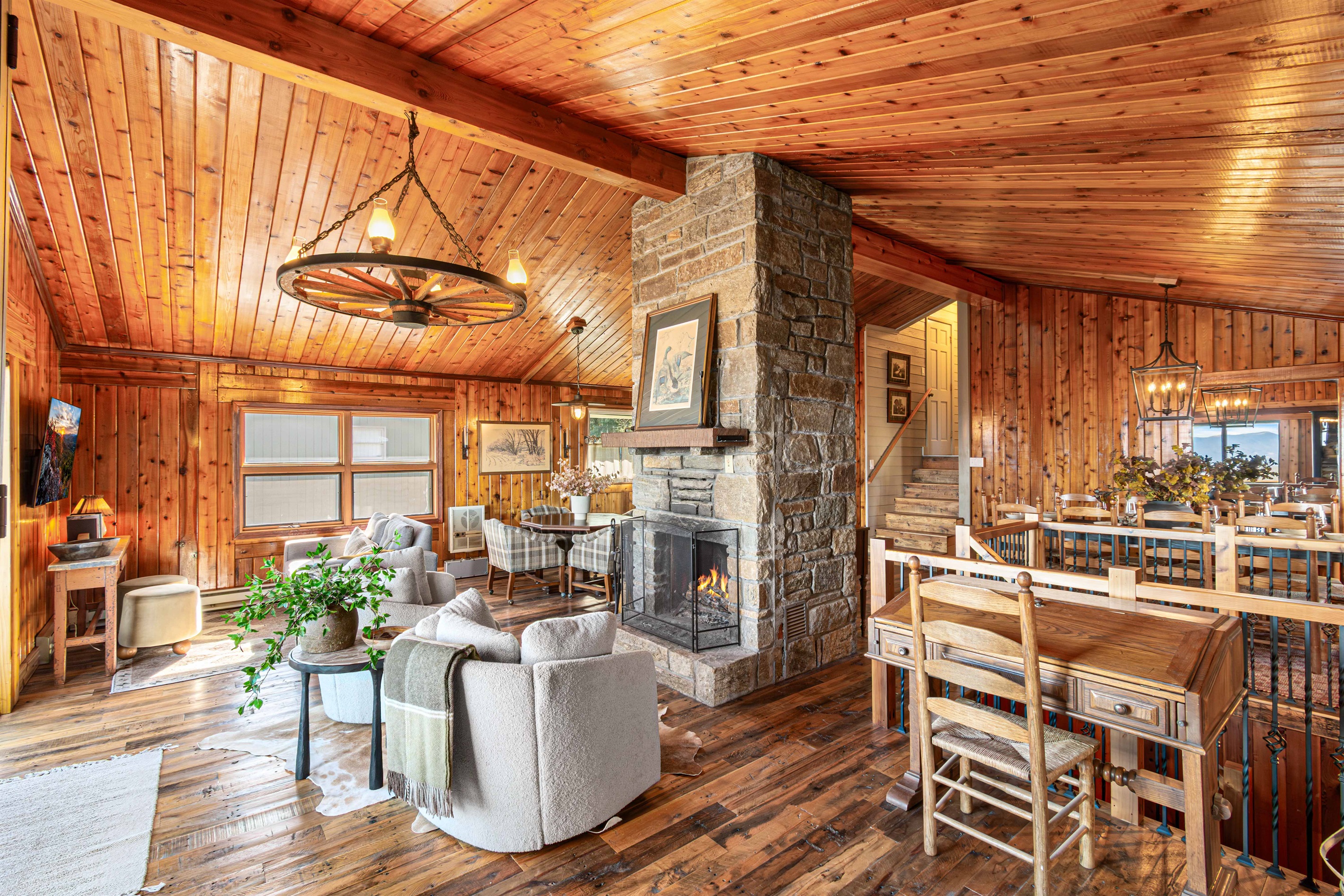 The original stone fireplace anchors this cozy vintage gathering room, blending lodge charm with warm, inviting spaces to relax and reconnect.