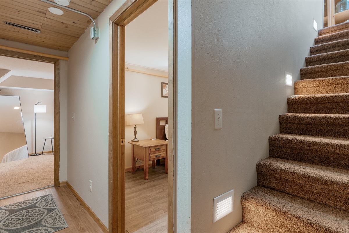 The bedrooms are down the stairs from the kitchen.