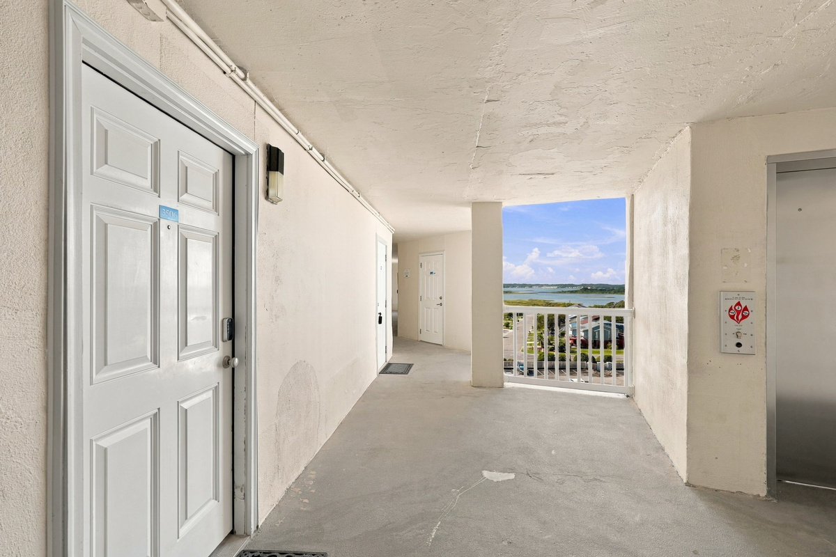 Covered outdoor entryway with views of the surrounding grounds as you arrive.