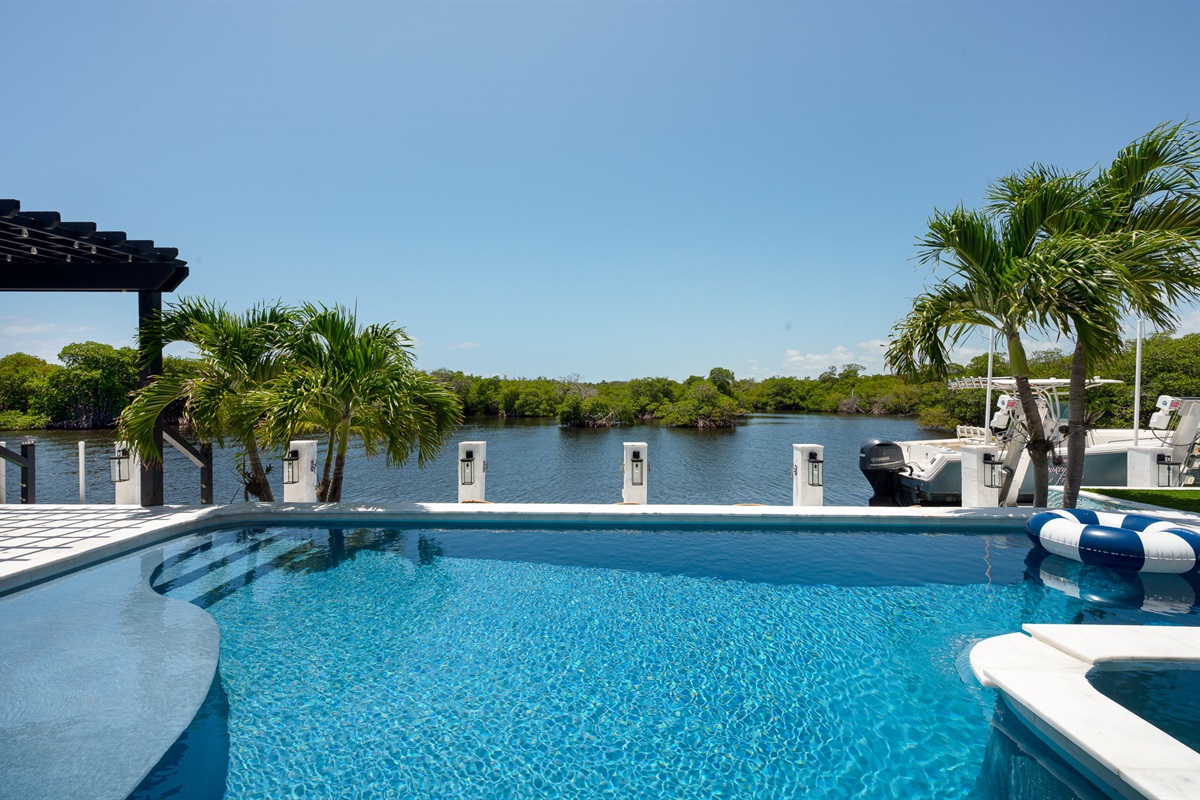 Your private waterfront paradise &mdash; complete with a pool, outdoor lounge, and your own dock for the ultimate coastal getaway.