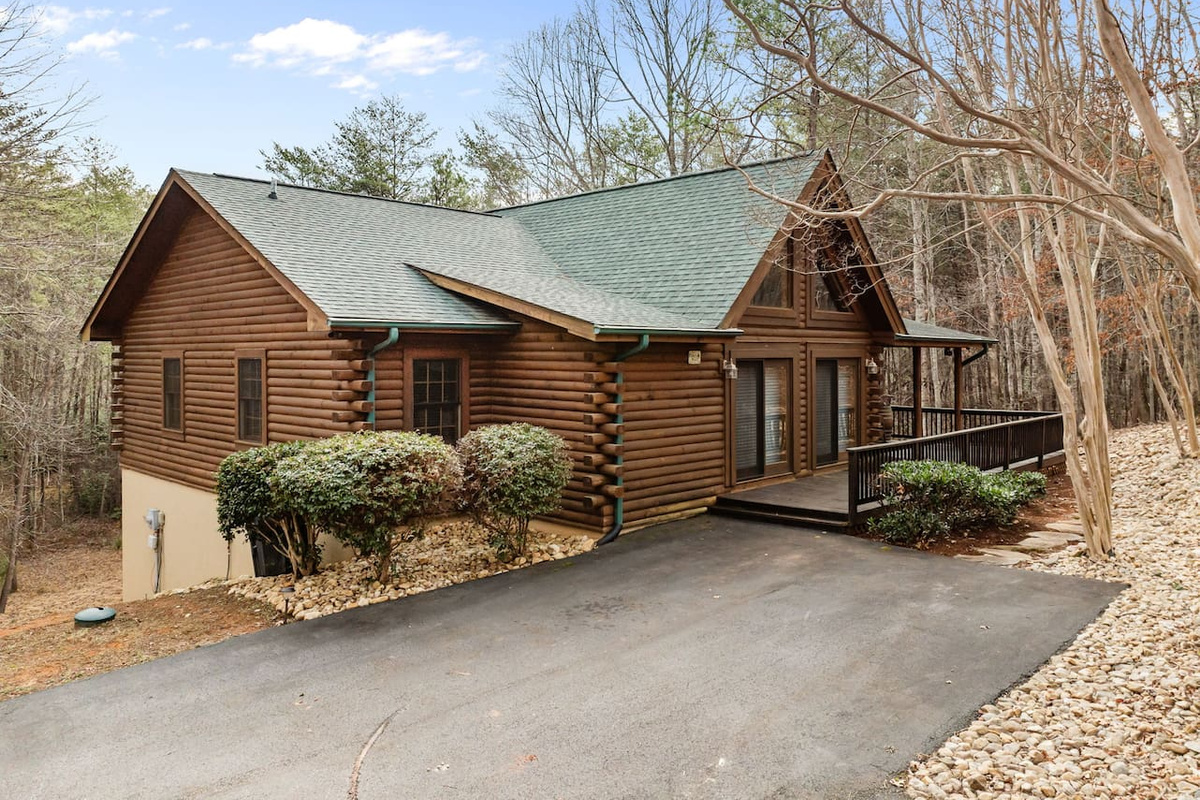 Front view of the cabin with paved driveway