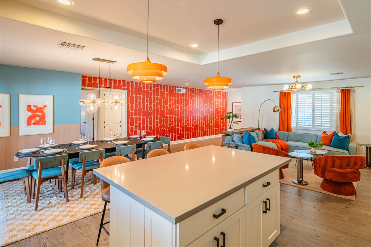 Expansive dining table and oversized kitchen island provide ample seating for shared meals, game nights, or hosting groups with ease.