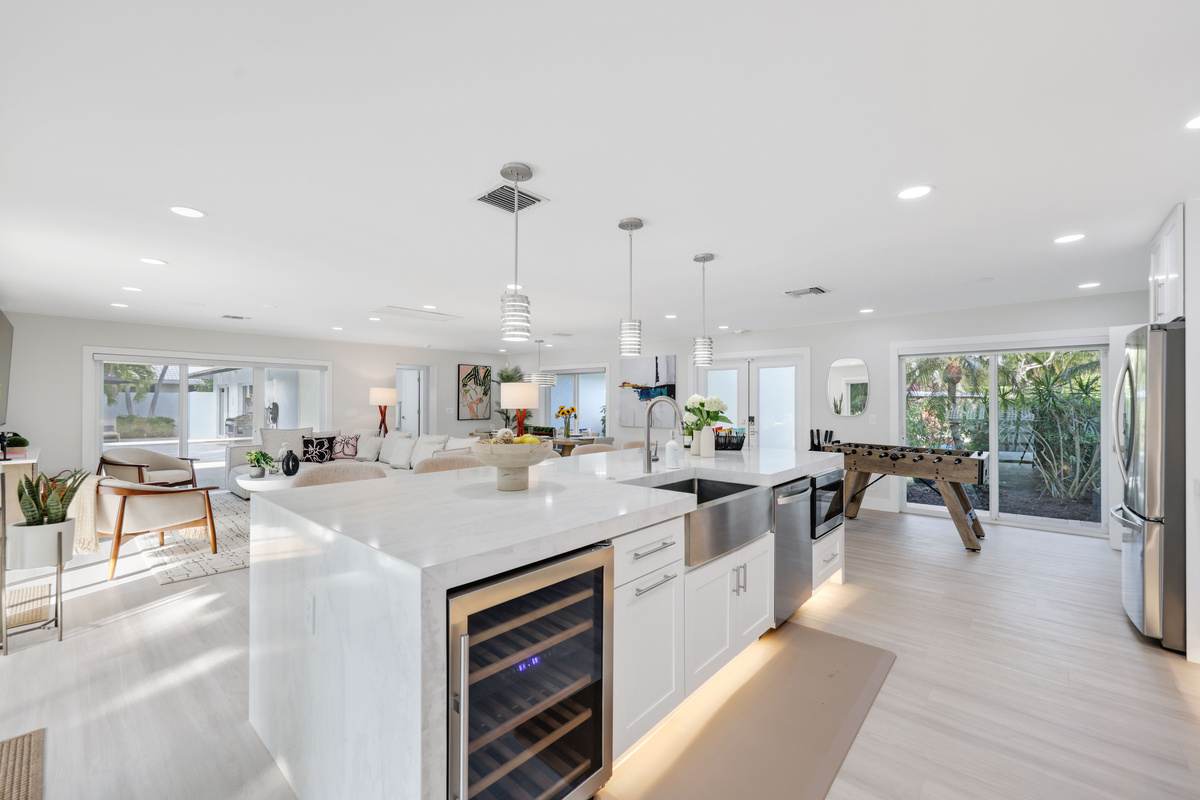 Cook, gather, pour a drink, and unwind in an open kitchen and living area with bar seating, foosball, and plenty of natural light.