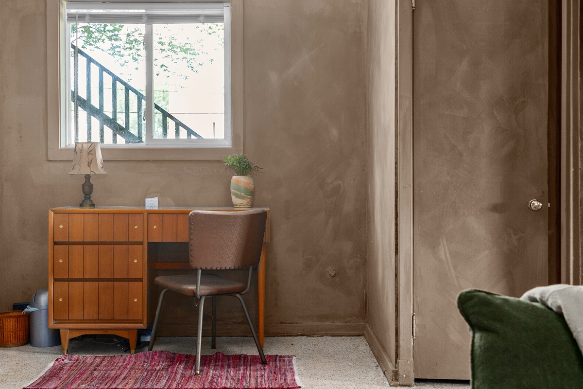 Quiet den with desk and chair for easy remote work.