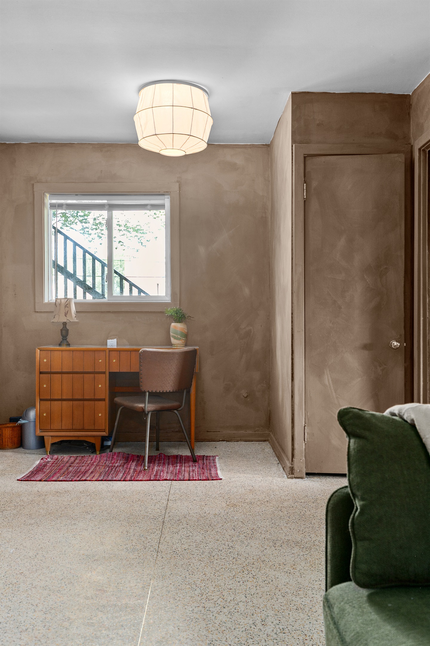 Quiet den with desk and chair for easy remote work.