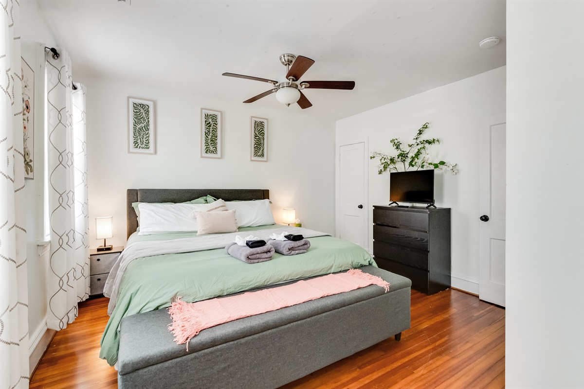 King Bedroom 2: Bright, inviting space with lush decor and a plush bed for restful nights!