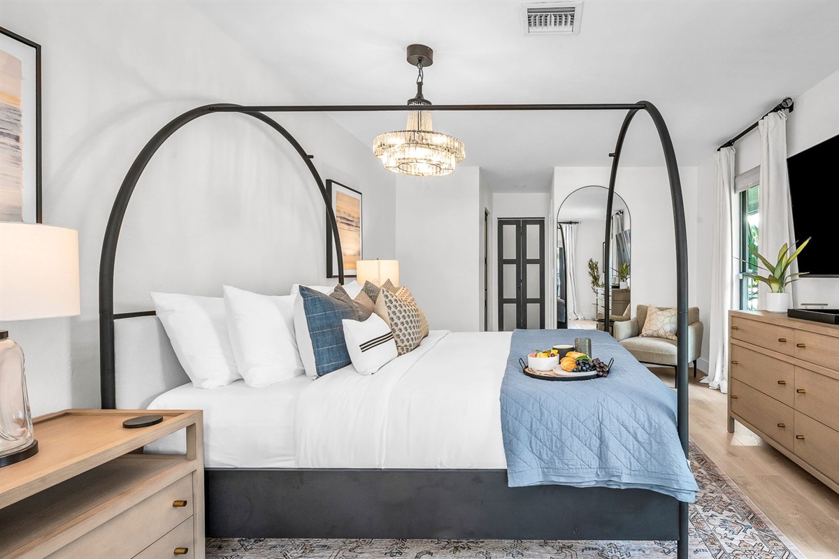 This second primary suite offers a plush king bed, private ensuite bathroom, and walk-in closet for added comfort. Enjoy poolside views and direct access to the outdoor living area, making it the perfect blend of luxury and convenience.