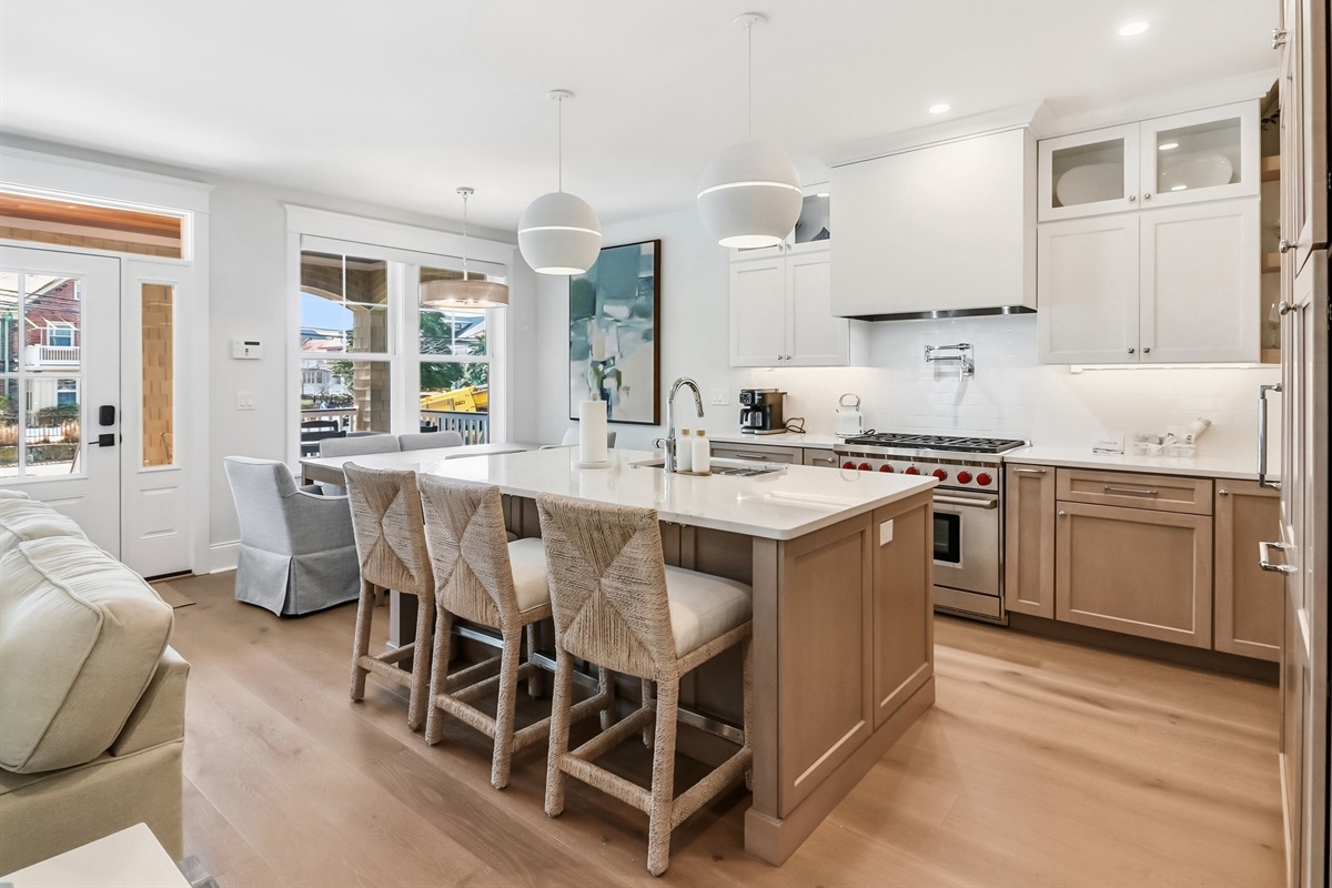 KItchen area and kitchen island which can seat three