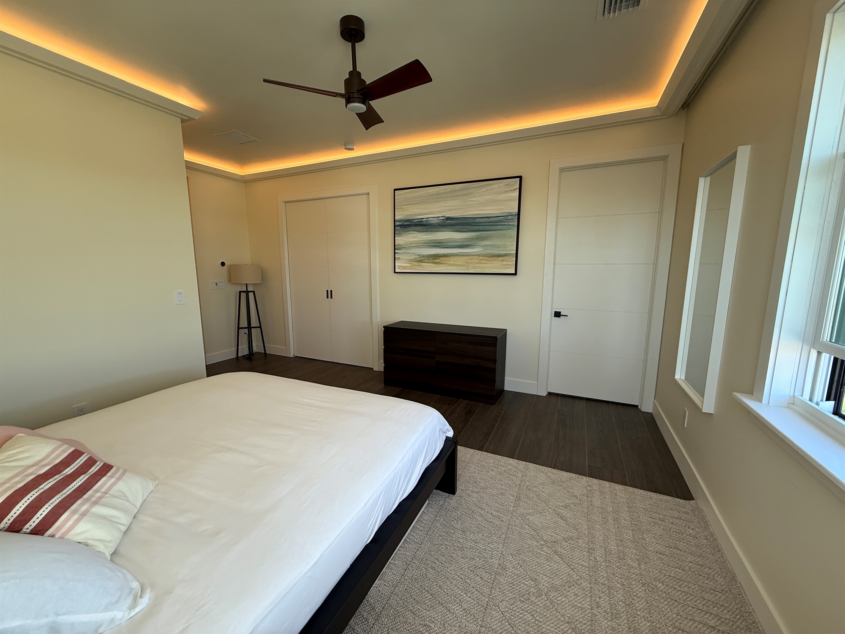 Primary king suite view to en suite bath and office doors closed