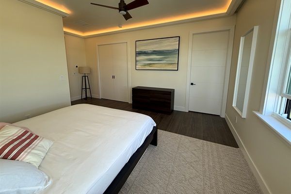 Primary king suite view to en suite bath and office doors closed