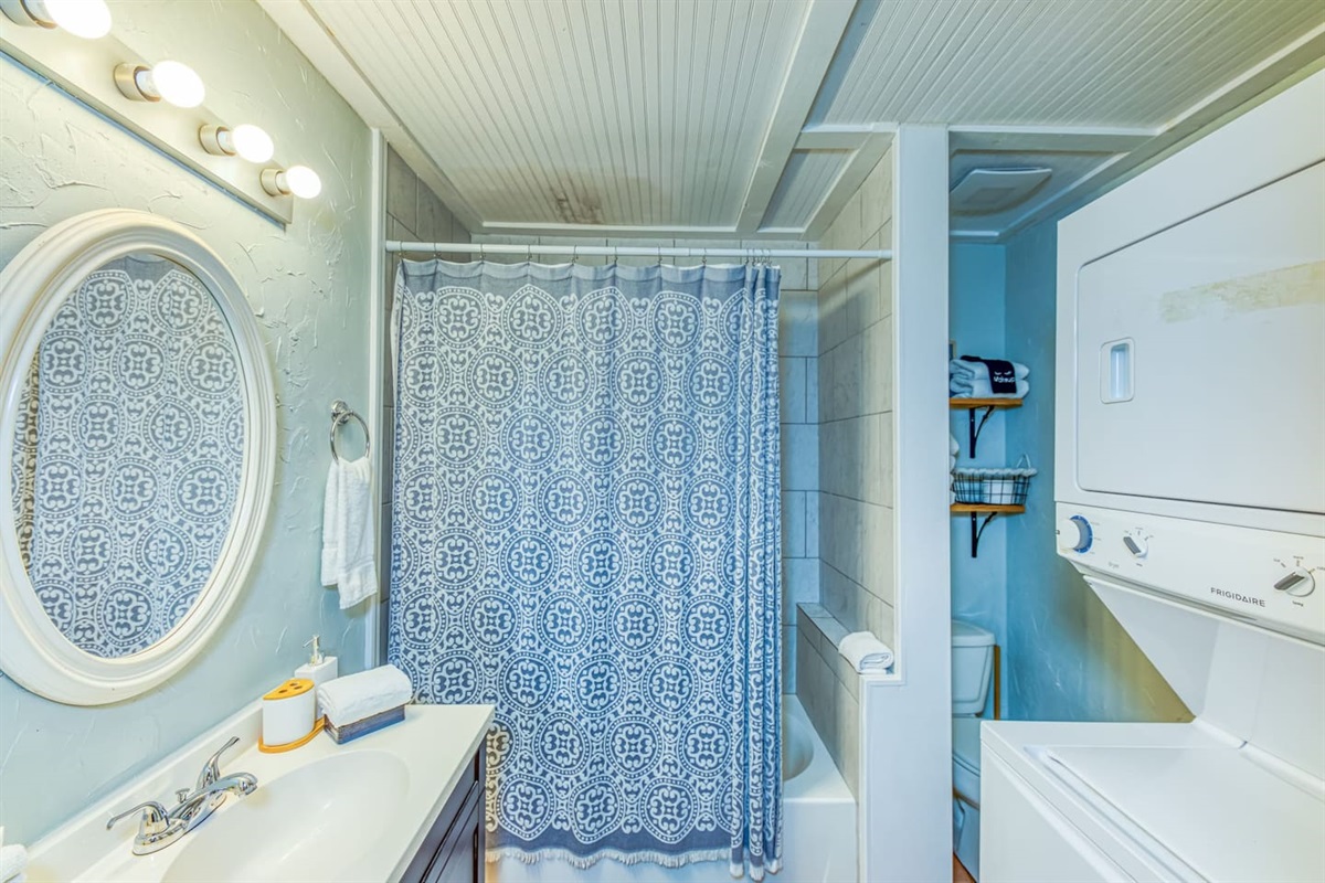 Bathroom Retreat: Bright and stylish space with modern fixtures and a convenient laundry area!