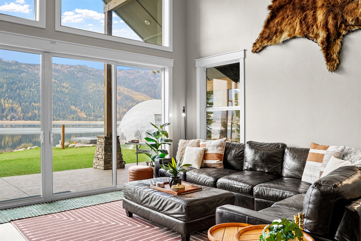 Spacious loft-style living room overlooks the serene private waterfront.