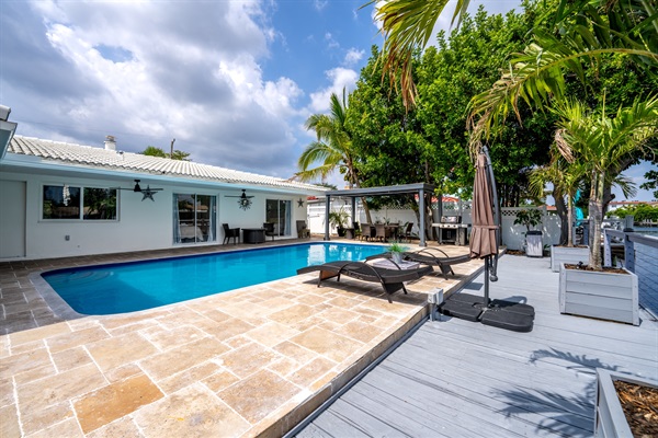 Resort-style waterfront pool and outdoor lounge area