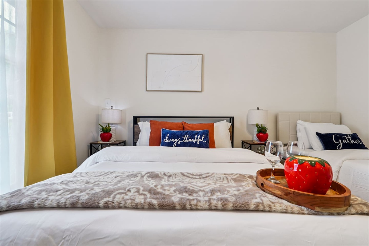 Another cozy bedroom featuring both a full bed and a twin bed, along with an Amazon Fire-powered Smart TV for your entertainment. This room includes 4 full-body towels, 4 washcloths, and 2 hand towels for your stay.