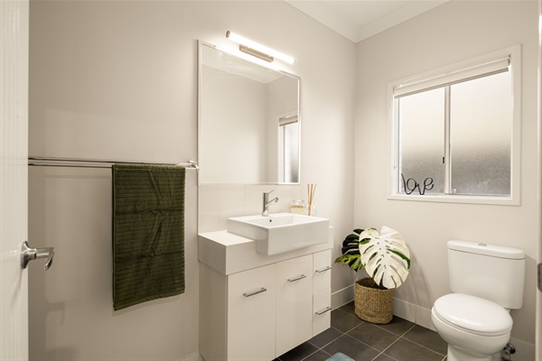 Private ensuite with large shower, vanity and toilet.