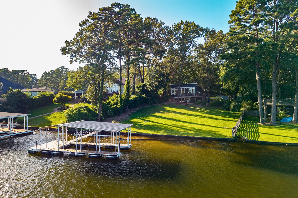 Private boat dock with easy water access and a sunny lakeshore lawn.