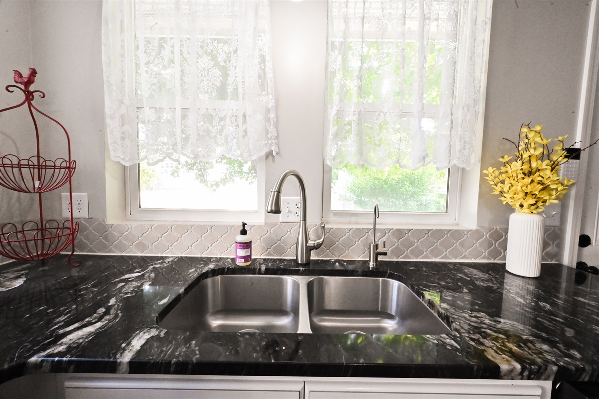 kitchen sink looks to backyard