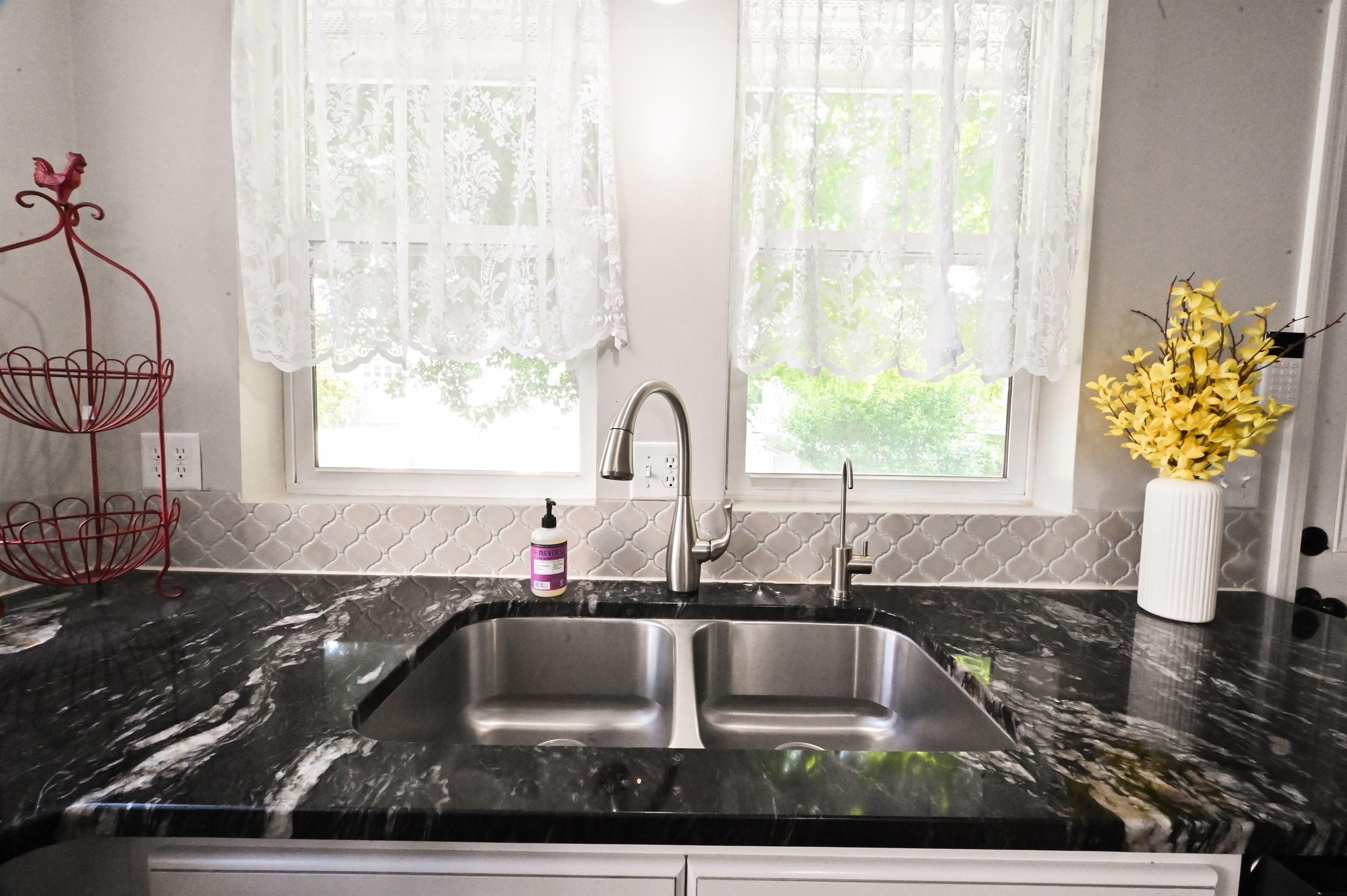 kitchen sink looks to backyard