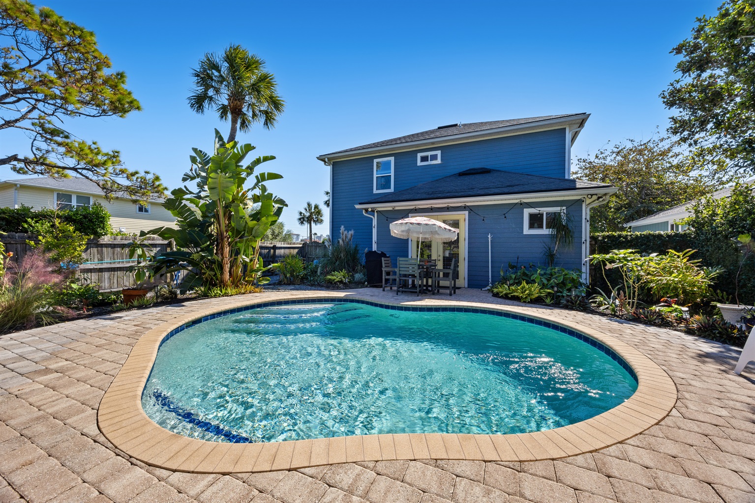 Sunny Backyard Pool Oasis
A sparkling kidney‑shaped pool surrounded by lush landscaping and a spacious patio. Comfortable seating and a shaded dining area create an inviting space for lounging and entertaining.